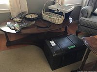 Photo shows entire lot on coffee table and floor including storage box, two baskets, metal wall clock and Canada geese wall art