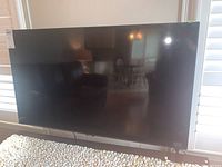 Front view of Samsung 43-inch TV on pebble-surfaced table
