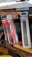 Close up of OEM Fix-A-Freek spark plug repair kit and packaged Mastercraft screwdriver bits
