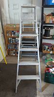 Front view of the aluminum step ladder showing the steps and top platform.