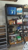 Full view of shelving unit with items on shelves, contents not included in sale.
