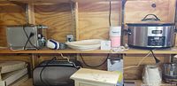Shelf with toaster, smoothie maker, platters, and Crock-Pot slow cooker