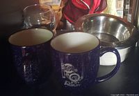 Blue ceramic mugs with dog agility logos, two mugs shown.