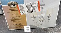 Box of Hampton Bay Gala 3 Light chandelier showing product image and label with specifications.