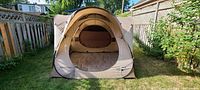 Front view of the Quechua pop-up tent showing separate sleeping and living compartments with front opening and ventilation.
