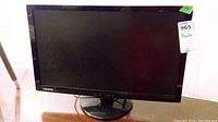 Front view showing black Lenovo monitor with stand and visible Lenovo logo on bezel.