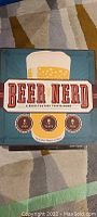 Beer Nerd board game in teal box with beer mug illustration, showing front cover and title.