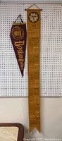 Photo showing the full 1964 Latin calendar hanging on a pegboard wall next to Boston College pennant.