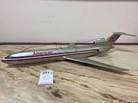 Full side view of the American Airlines Astro Jet model airplane showing 31 inch length and hanging wire attached to the top.