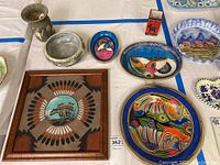 Full lot overview showing 7 pieces including bowls, plates and framed art with Native American style design.