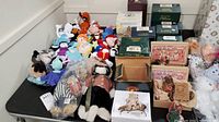 Full view of plush Bullwinkle CVS beanie collection, plush Boyds Bears, and boxed Boyds Bears figurines on table