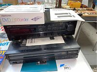 Front and top view of Denon stereo receiver stacked on Denon 5 disc CD player, with Memorex DVD recorder box on top.