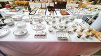 Overview of Portmeirion Botanic Garden set with plates, bowls, cups, saucers, mugs, spice jars and pitcher on table
