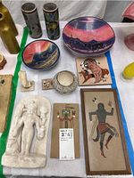 Overview photo showing all 11 pieces including vases, platters, bowl, prints and sculptures together on a table.