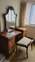 Full view of vanity with attached mirror and matching stool