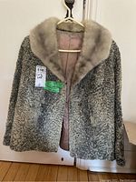 Full front view of the curly wool jacket with mink collar showcasing the texture and collar detail.