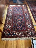 Full view of the entire rug laid flat on hardwood floor