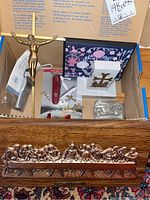 Overview of full lot including wood plaques with crosses, crucifix figurine, Victorinox knife, belt buckle and breathalyzer in box