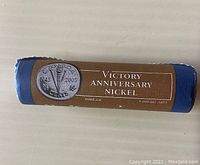 Blue coin roll with brown English label showing Victory Anniversary Nickel with 1945-2005 torch coin image.
