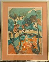 Full view of framed lithograph artwork showing abstract village landscape with trees in vibrant colors and peach matting.