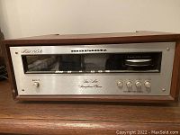 Front view showing silver faceplate, tuning window, push-buttons and knobs