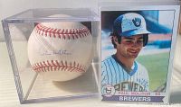Autographed baseball by Paul Molitor in a clear protective case alongside a Paul Molitor Brewers baseball card.