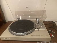 Full view of Pioneer PL-516 record player with dust cover open, showing platter and tone arm.