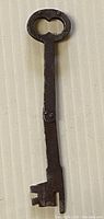 Full view of the folding key extended showing metal shaft, bow handle and bit extended
