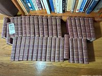 Harvard Classics volumes arranged in two rows, showing spines with title lettering and volume numbers.