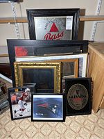 Framed Bass Beer mirror, gold framed mirror, various stacked frames, small sports art and Patriots print.