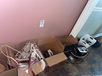 Overview of boxes containing multiple phones and cords, showing quantity and packaging condition