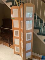 Overall view of the wooden picture frame stand with 3 panels, showing front and side angles.
