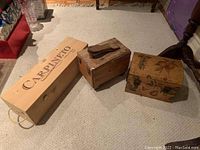 Top view of three wooden boxes showing varied sizes and designs including the Carpineto box