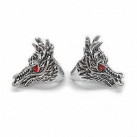 Front view of the two Chinese Miao silver dragon head rings showing detailed dragon face and red gemstone eyes.