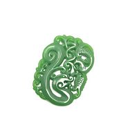 Close-up photo of green jade pendant carved in Asian dragon motif with detailed scales and curling design.