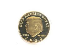 Obverse side of the gold plated commemorative coin showing a profile of Donald Trump with inscriptions 'KEEP AMERICA GREAT!', 'IN GOD WE TRUST', and '2020'.