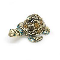 Enameled and bejeweled mother and baby sea turtle ring box shown from front angle, showcasing detailed textured shell, blue rhinestones on head and flippers, baby turtle resting on top.