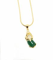 Front view of the green jade Pixiu pendant on the gold filled snake chain against a white background.