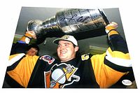 Photo showing Mario Lemieux holding the Stanley Cup, signed in black ink with RPM Authentic sticker visible.