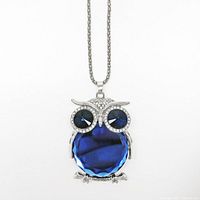 Front view of the owl pendant necklace showing the large faceted blue stone body and blue eye stones with rhinestone accents on a silver-tone Cuban chain.