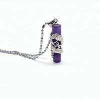 Close-up side angle of lavender jade pillar pendant with white gold plated dragon detail and chain.