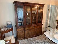 Full view of the Kaufman of Collingwood wooden china cabinet with three glass doors on the upper section and wood panels on the lower section
