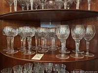 Shelf showing all eighteen cut crystal wine glasses, both sizes