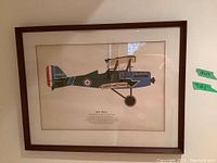 Close-up of a framed print showing 1917 S.E.5 biplane side profile with text beneath.