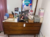 Front view of wooden dresser with items on top