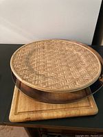 Wooden cutting boards: two rectangular and one round with woven rattan center