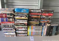 DVD stacks showing multiple TV series and movies, with notable large blue Star Trek case visible on top