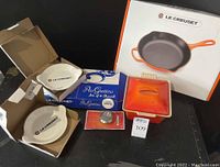 Full view of all items: square casserole with lid, Au Gratin box, skillet box, replacement knob in package