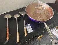 Top view of Simply Ming 13-inch purple wok with lid and three utensils: two ladles and one spatula