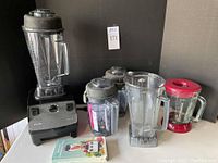 All components displayed together: blender base, pitchers, glass attachment and manual